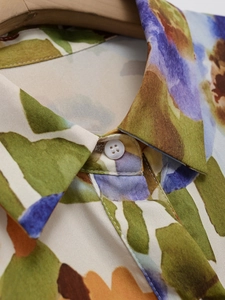 Close-up of elegant floral print shirt with neat collar stitching and white buttons