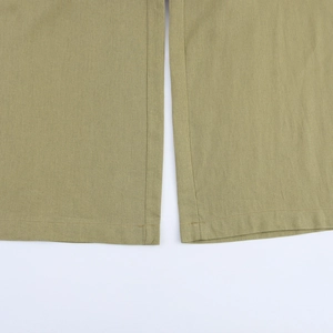 Close-up of olive green wide leg pants showing high-quality hem stitching and cotton texture