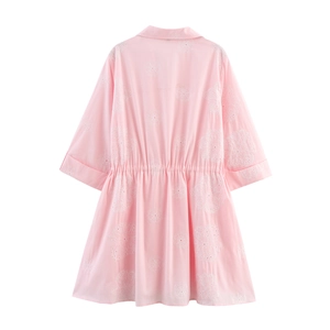 Detailed back view of pink mini dress with white floral embroidery and elastic waist