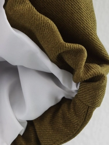 Detail of olive green corduroy jacket fabric with smooth white inner lining