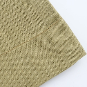 Detailed close-up of khaki woven fabric showing premium linen texture and stitching