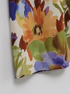 Close-up of floral print fabric with precise white single-needle stitching detail