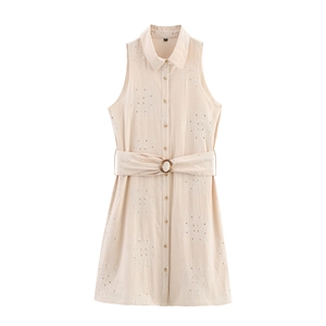 Close-up of beige sleeveless dress with intricate floral embroidery and matching fabric belt