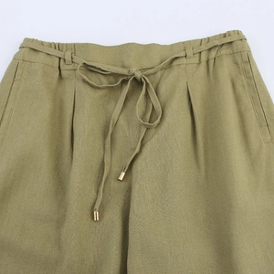 Elastic high waistband detail of linen wide-leg pants with drawstring and metallic tips