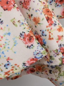 Close-up of lightweight floral fabric showing detailed twill texture and neat overlock stitching