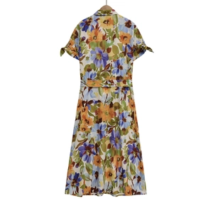 Detail view of the back of floral summer dress featuring vibrant blue and orange patterns