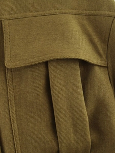 Detailed macro view of olive green cargo jacket with twill texture and flap pocket