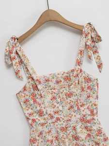 Floral print summer mini dress with bow shoulder straps and square neckline on hanger