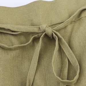 Detail of high-waisted linen drawstring waist with natural knot on olive wide-leg pants