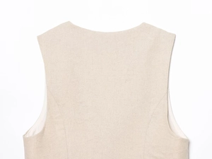 Detailed close-up of beige cotton-linen vest neckline with reinforced topstitching