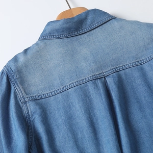 Detailed back view of Tencel denim shirt showing yoke stitching and washed texture