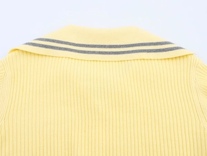 Close-up of bright yellow ribbed knit collar with grey contrast stripes on the edge