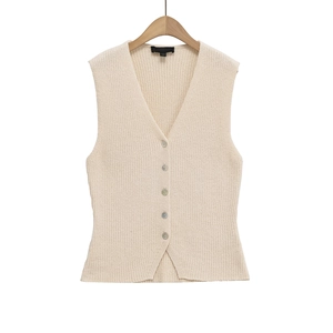 Détail du gilet en tricot à col en V avec boutons nacrés et texture à côtes fines