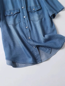 Women's loose denim short sleeve shirt with dual chest pockets and snap buttons
