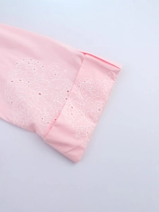 Pink eyelet mini dress featuring white mandala embroidery and hollow-out detailing