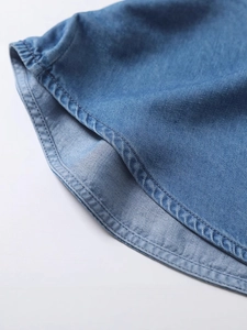 Women's loose denim short sleeve shirt featuring curved hem with fine double-needle stitching