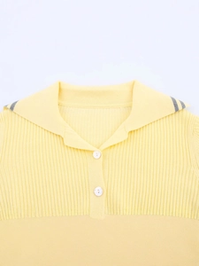 Women's yellow knit polo shirt with contrast striped collar and button detail