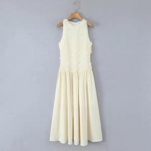 Detailed view of cream maxi dress featuring 3D rose floral texture and pleated skirt