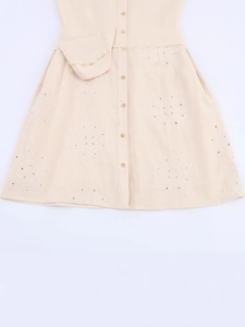 Sleeveless beige mini dress with floral embroidery and button detail in summer style