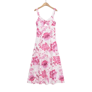 Detail of white summer dress with pink tropical floral print and center cutout