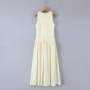 Detail of elegant cream maxi dress featuring 3D floral texture and pleated skirt