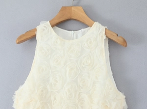 Detail of 3D rose floral texture on sleeveless cream maxi dress with back zipper
