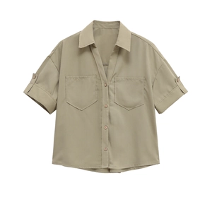 Detailed flat lay of khaki short sleeve shirt with lapel collar and chest pockets