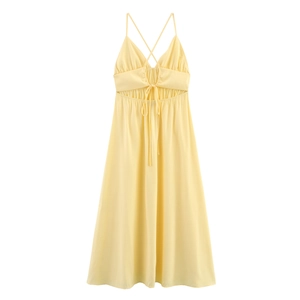 Detail of light yellow backless dress featuring deep V-neck, ruched bust, and lace-up back