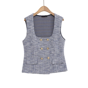 Close-up of blue tweed waistcoat with golden buttons and textured weave detail