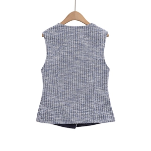 Detail of tweed texture and tailored back seam on blue and white sleeveless vest