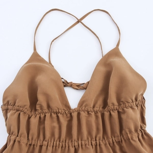 Detail of caramel V-neck backless dress with spaghetti straps and elastic pleats