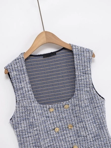 Detail of blue tweed vest featuring square neckline and four decorative gold buttons
