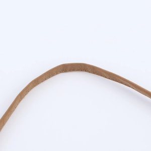 Detailed macro view of the brown woven strap featuring high-quality reinforced stitching