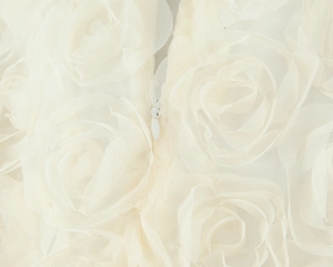 Detail of floral mesh fabric with a concealed zipper on an elegant white maxi dress