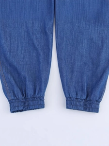 Women's loose high waist blue denim jogger pants with elastic cuffs and orange stitching