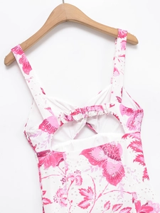 Detail of white dress with eyelet embroidery, pink floral print and elastic back