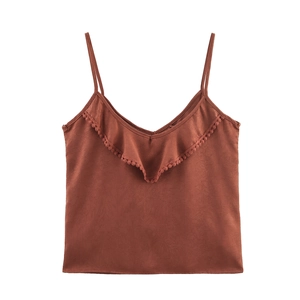 Detail of rust red camisole featuring delicate ruffle edges and textured fabric finish