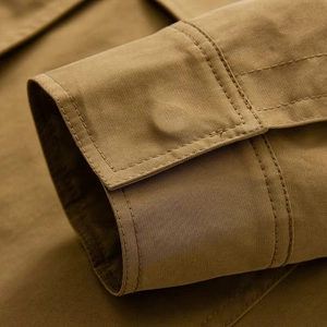 Close-up of high-quality stitching and fabric texture on khaki utility jacket cuffs