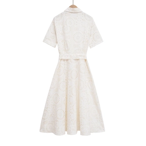 Close-up of white eyelet embroidery and hollowed-out details on this summer cotton dress