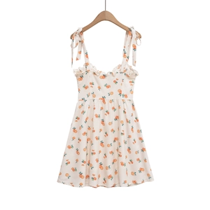 Detail of summer A-line dress with citrus print, ruffled neckline and tie-up straps