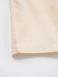 Macro shot of beige linen texture fabric with clean hemline stitching detail