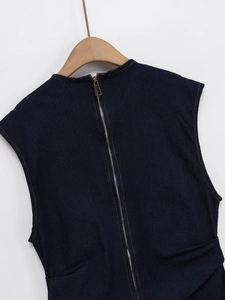 Detail of dark blue denim dress back featuring a silver metal zipper and frayed neckline