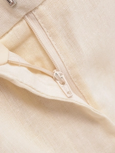 Detail shot of the beige cotton linen vest set showing the seamless YKK zipper and fabric texture