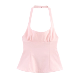 Detail view of pink halter neck top with bow design and pleated chest texture