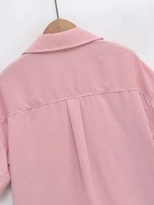 Detail shot of pink short sleeve shirt featuring back yoke and central box pleat