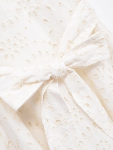 White embroidered eyelet shirt dress with short sleeves and front bow detail