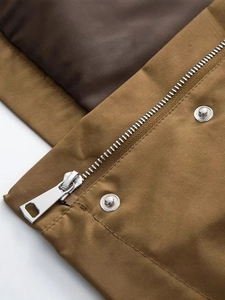 Front view of khaki workwear jacket featuring a metal zipper and stand collar detail