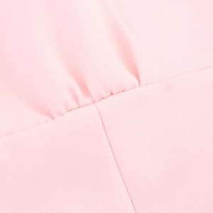 Detailed macro view of pink halter top fabric showing fine stitching and pleated texture