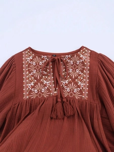 Rust red bohemian long-sleeved dress with floral embroidery and tassel drawstring v-neck