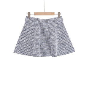Detail of tweed A-line mini skirt with blue and white woven pattern and wide waistband